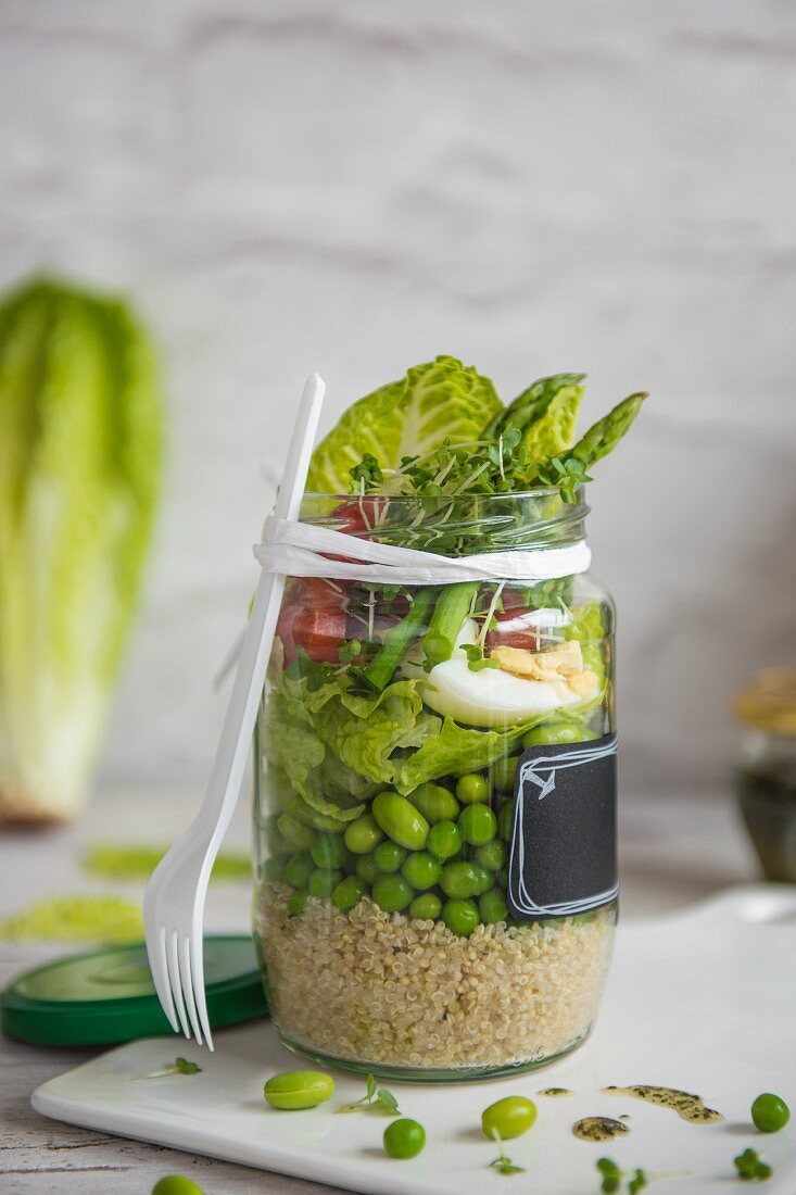 Bean and egg salad with quinoa and minted dressing in a jar for lunch
