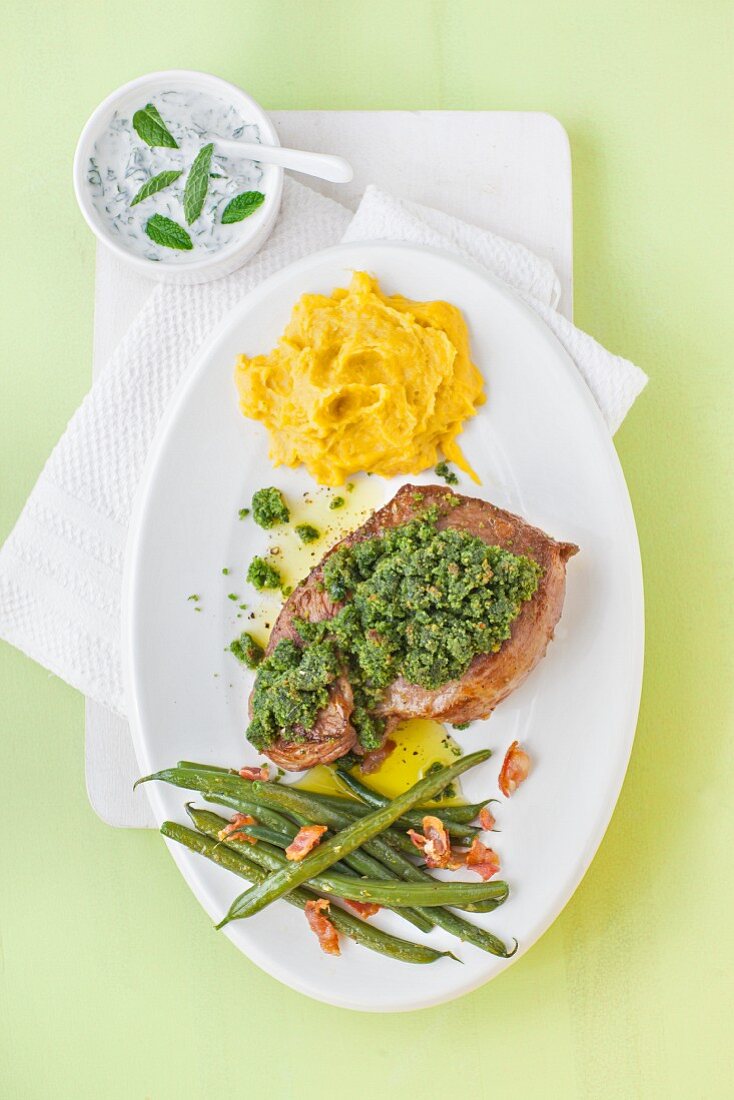 Leg of lamb with a herbed crust, dip, carrot and potato mash and green beans