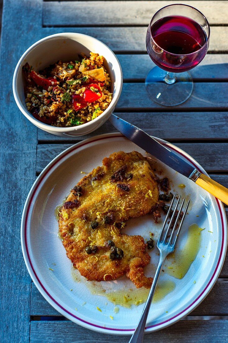 Breaded turkey schnitzel with lemon and caper sauce