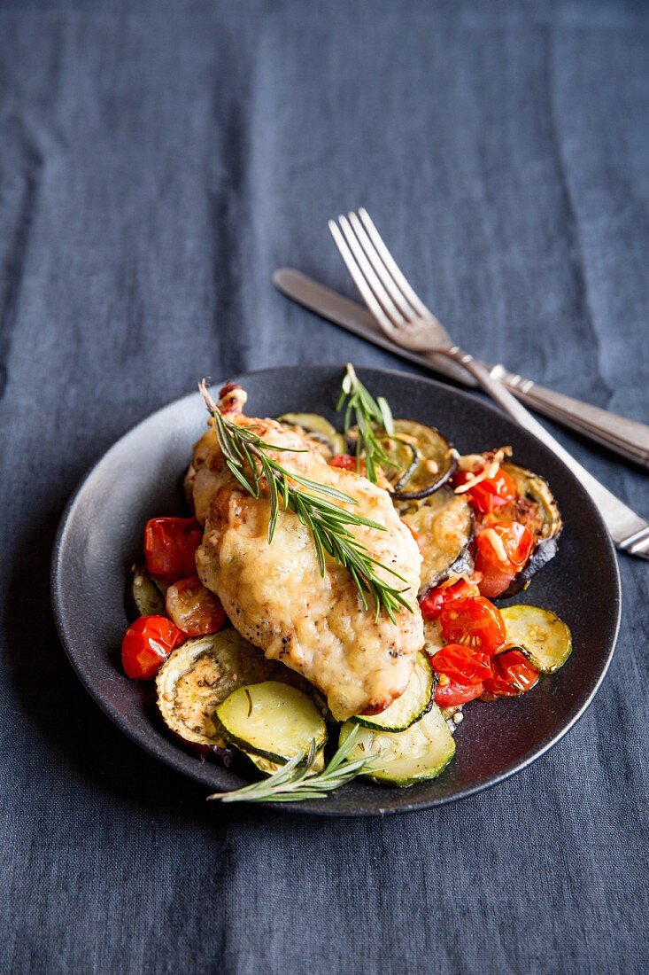 Chicken on a bed of ratatouille with rosemary