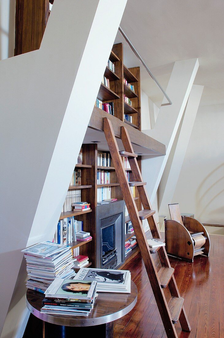 Bücherwand auf zwei Etagen mit einer Holzleiter