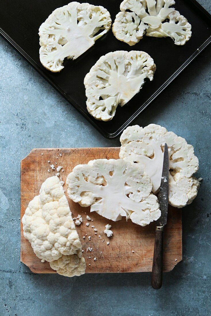 Cauliflower cut into steaks on a wooden board