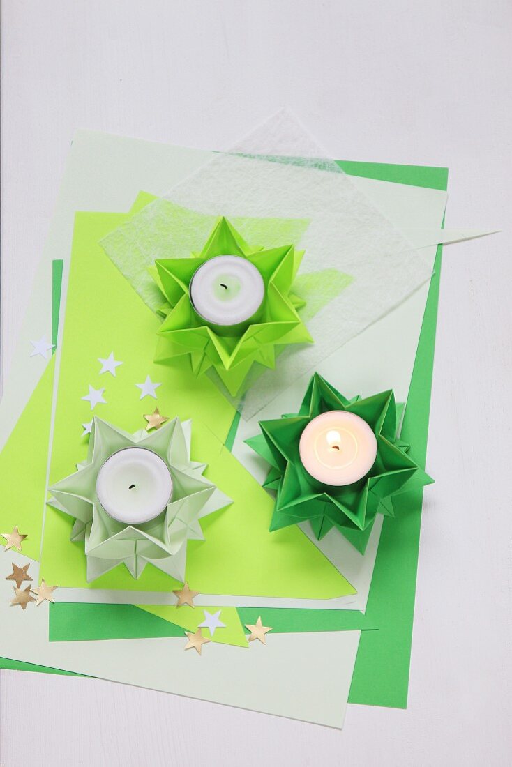 Folded green paper stars used as tealight holders