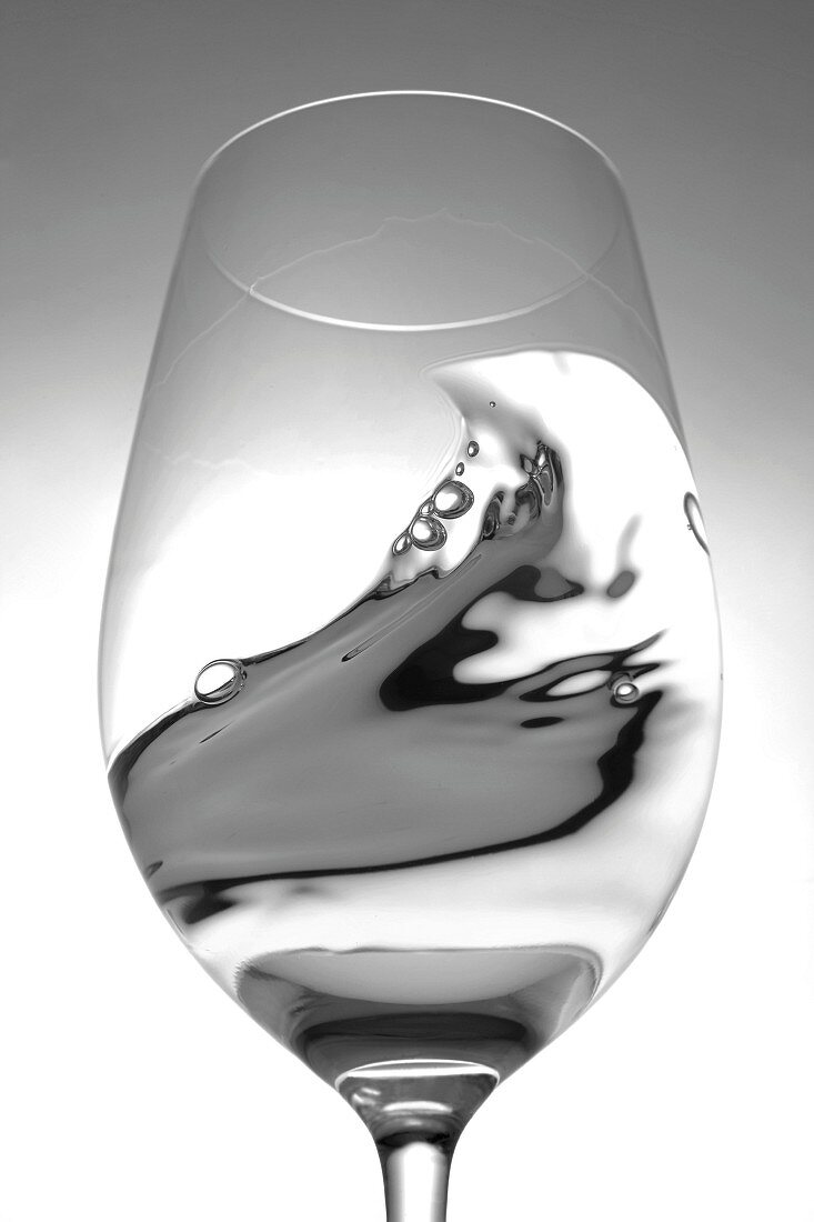 White wine in a glass with a wave