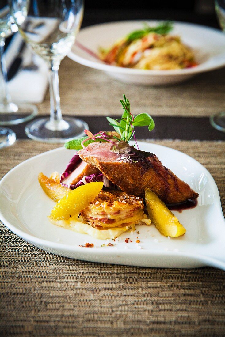 Gourmet roast pork with side dishes in a restaurant