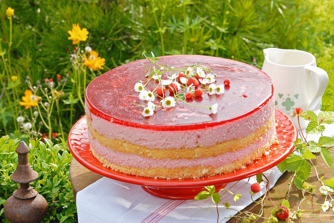 Strawberry cheesecake on a table in greenery