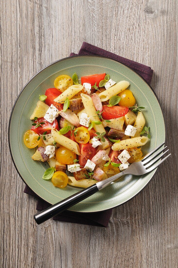 Mediterranean pasta salad with tomatoes, onions and feta