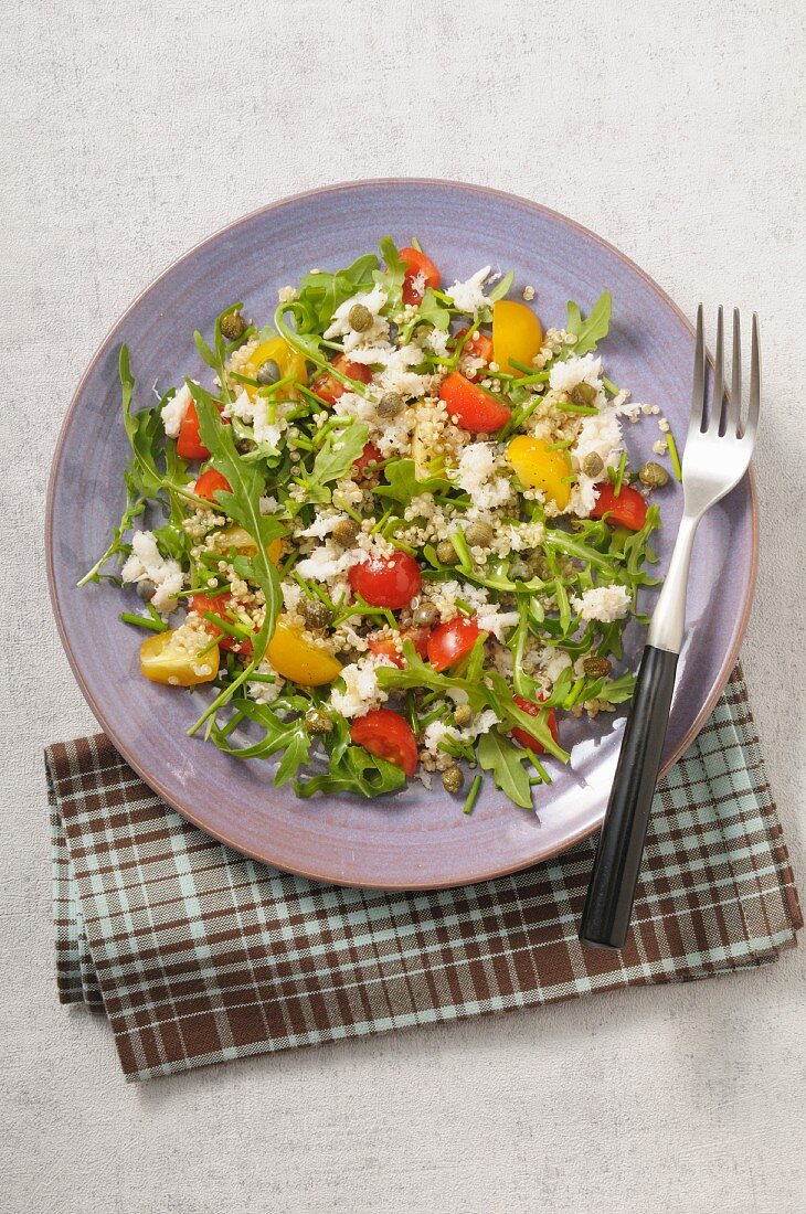 Quinoa salad with crab meat, tomatoes and arugula