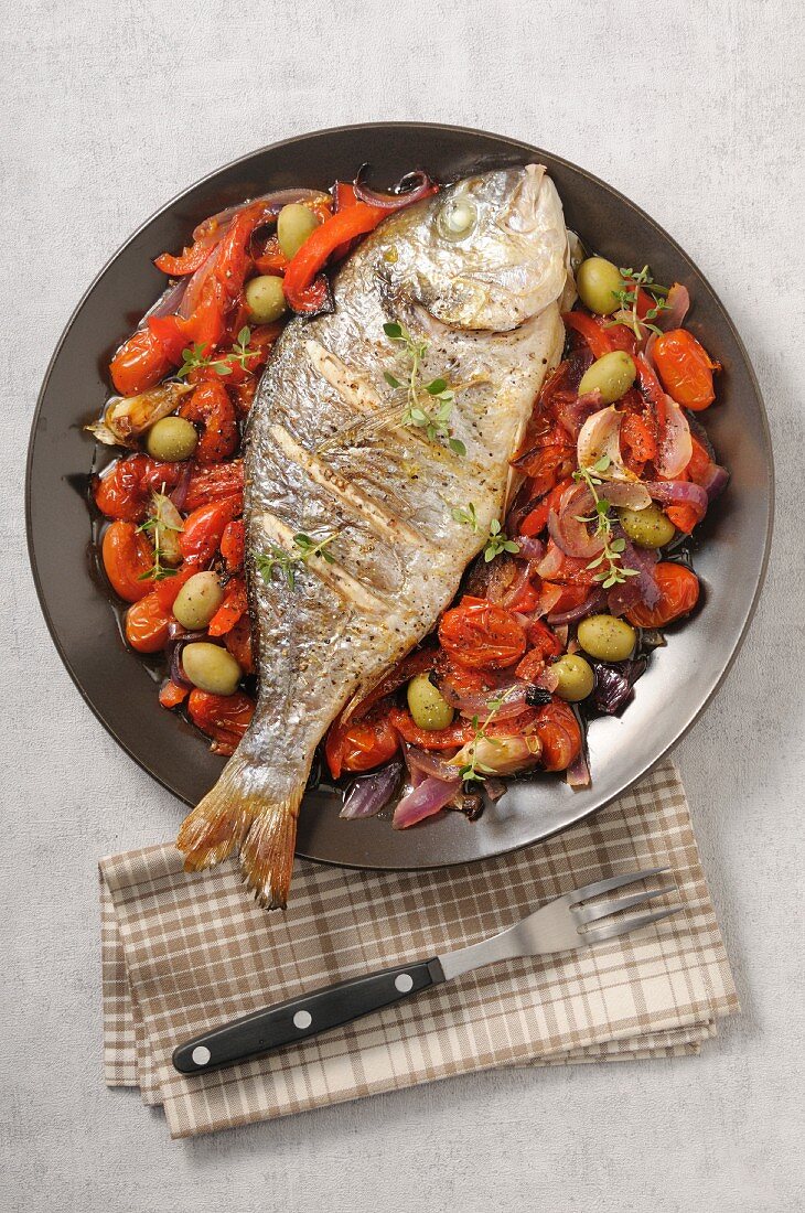 Grilled dorade with tomatoes and olives