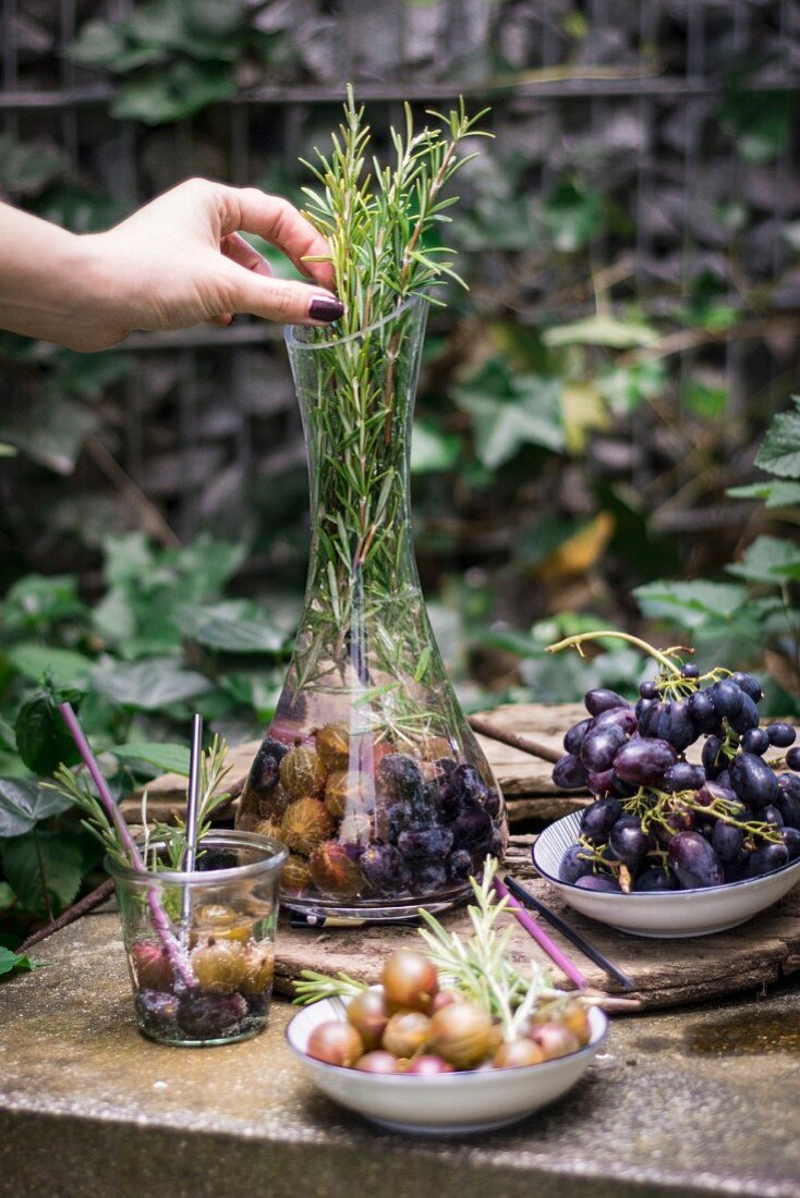 Gooseberry water with grapes and rosemary in a caraffe