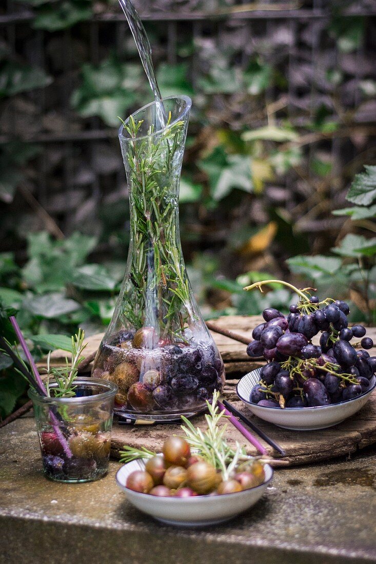 Gooseberry water with grapes and rosemary in a caraffe