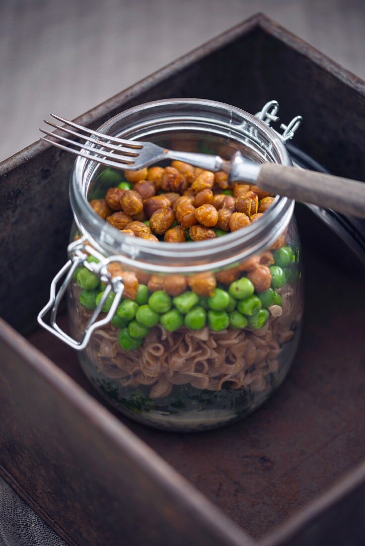 Spelt pasta, peas, broccoli, roasted chickpeas and dill sauce in a glass jar