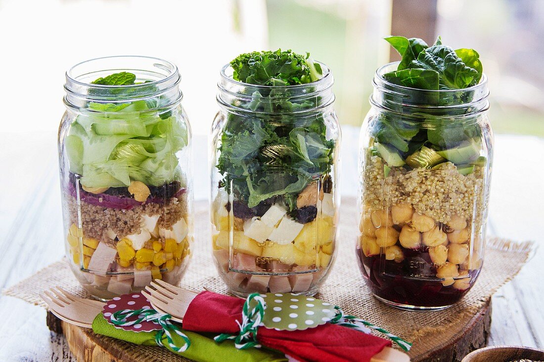 Different salads in jars prepared for a brunch in a buffet