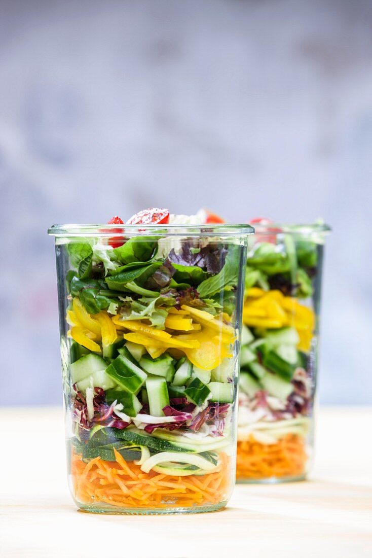 A layered vegetable salad in a glass