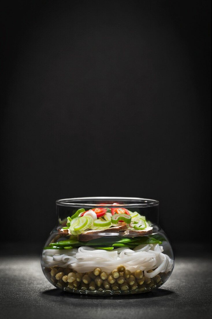 Noodle soup with vegetables in a glass bowl (Asia)