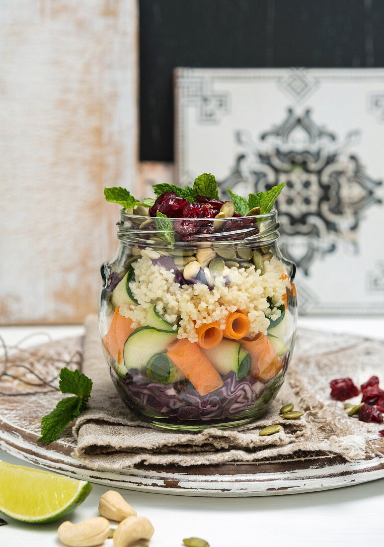 Vegan couscous salad with red cabbage and cranberries in a jar