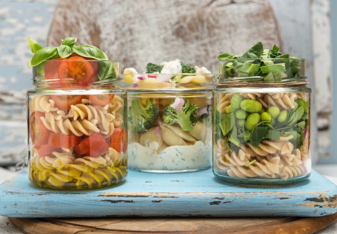 Verschiedene vegane Nudelsalate in Gläsern