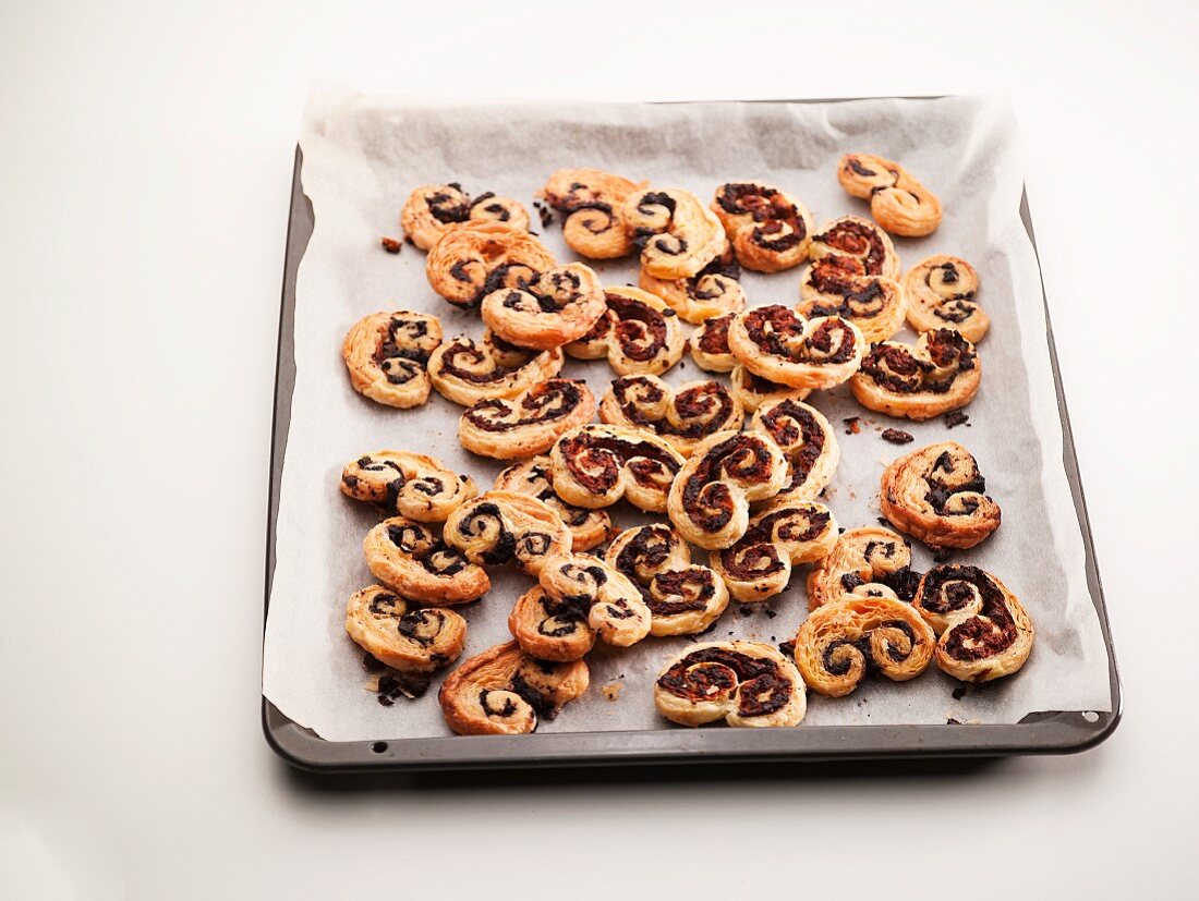 Palmiers filled with chocolate on a baking sheet