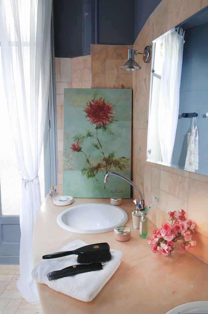 Floral artwork on washstand in classic bathroom