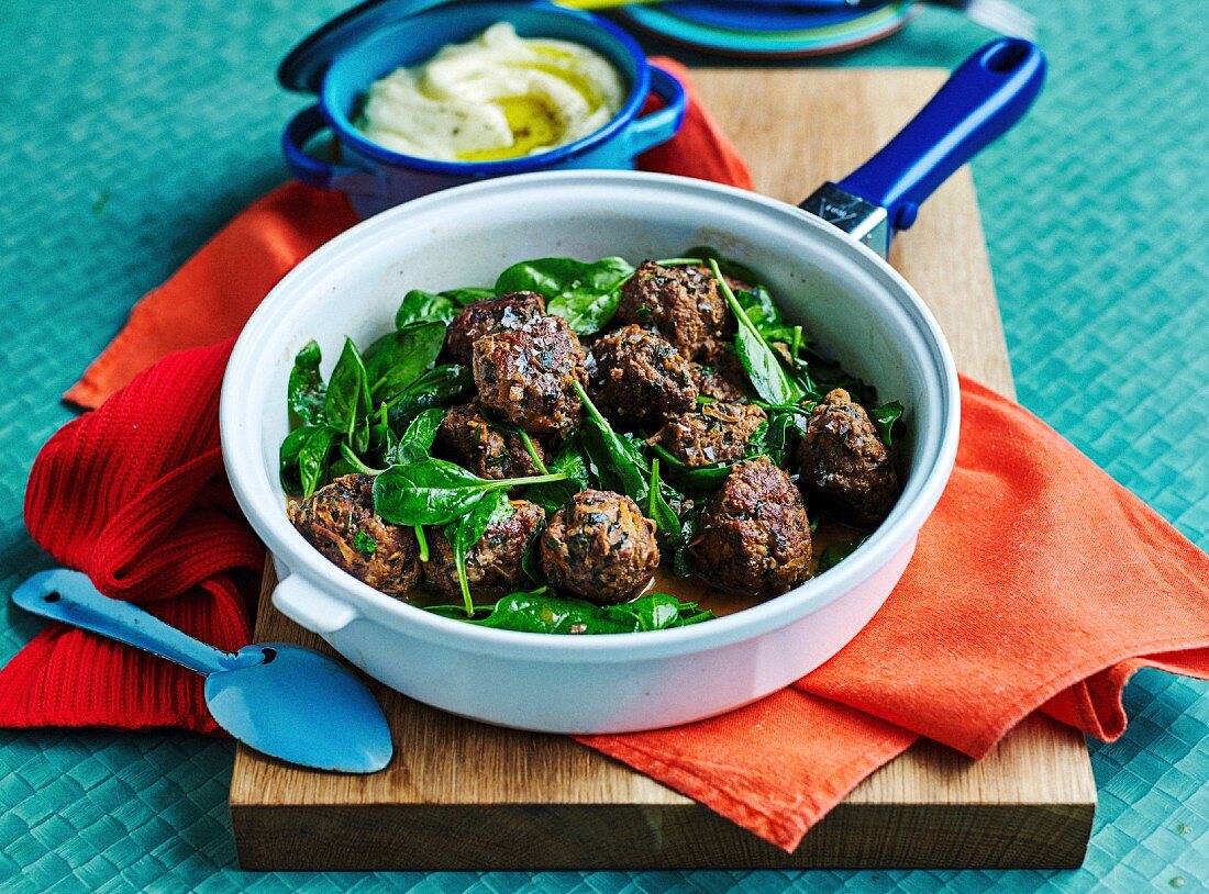 Beef and herbs meatballs with spinach,