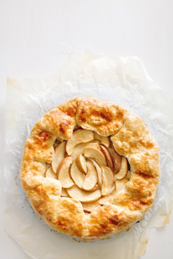 Galette with apples and cinnamon on parchment paper