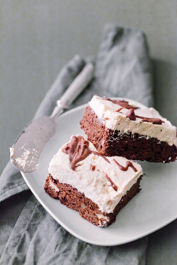 Brownie with vanilla cream mousse on a white plate