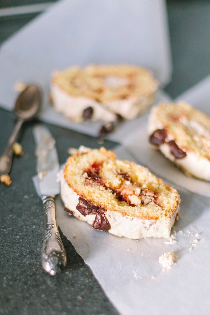 Biscuity roll with fruit and chocolate filling on a white parchment