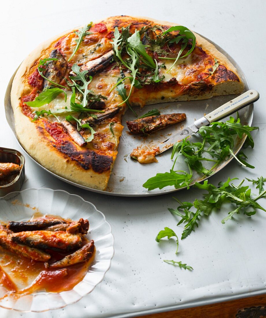 Pizza with sardines and rocket