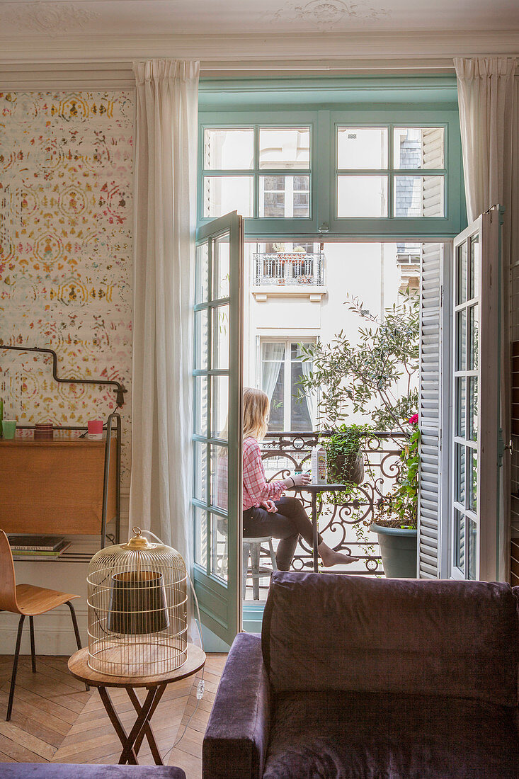 View of woman on balcony from living room