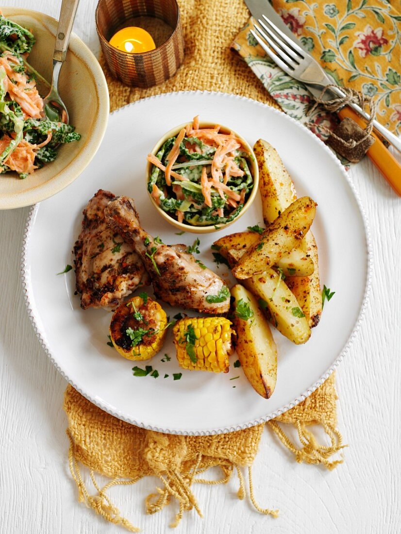 Chicken breast with corn, potato wedges and a mixed salad (Cajun cuisine)