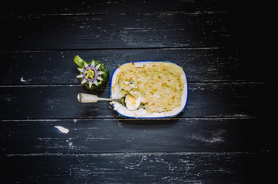 Fish pie with hard boiled eggs in an enamel dish