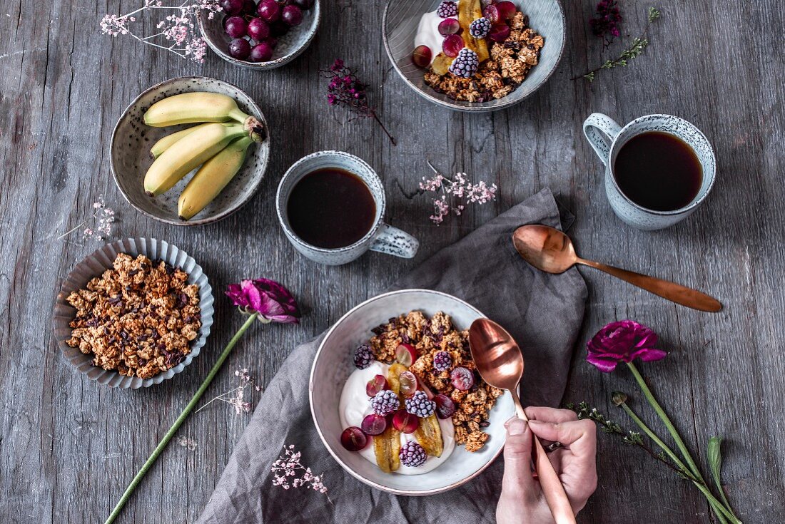 Peanut butter granola with chocolate chips, mini bananas, grapes, coconut milk yoghurt and frozen blueberries