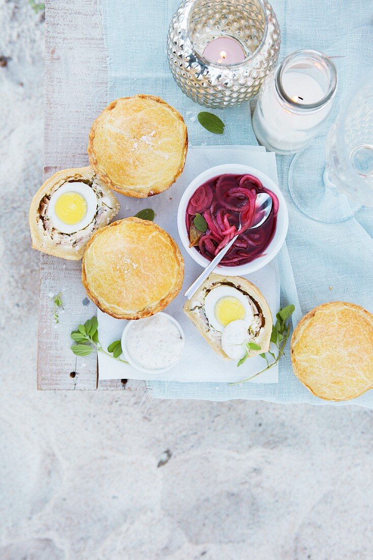 Small chicken pies with eggs and red onions