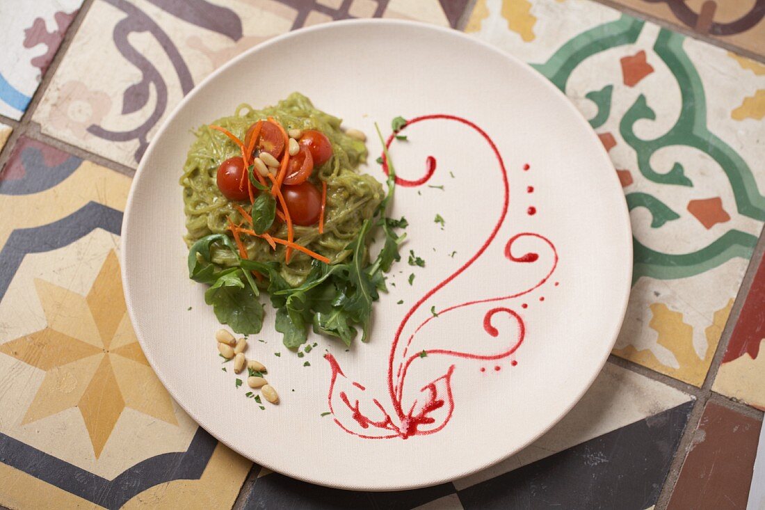 A cucumber salad with rocket, cherry tomatoes and pine nuts