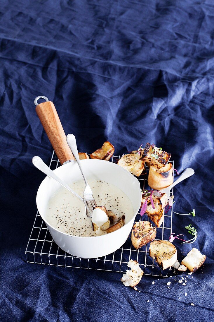 Traditional cheese fondue with toasted bread