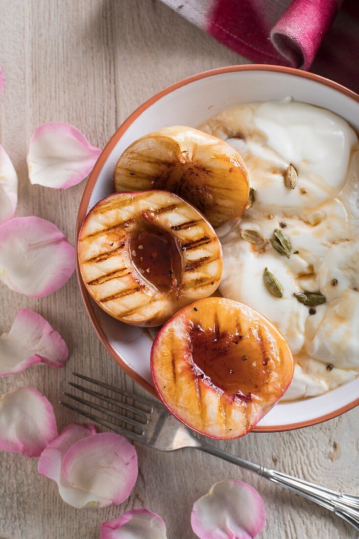 Grilled peaches with maple syrup and cardamom on Greek yogurt