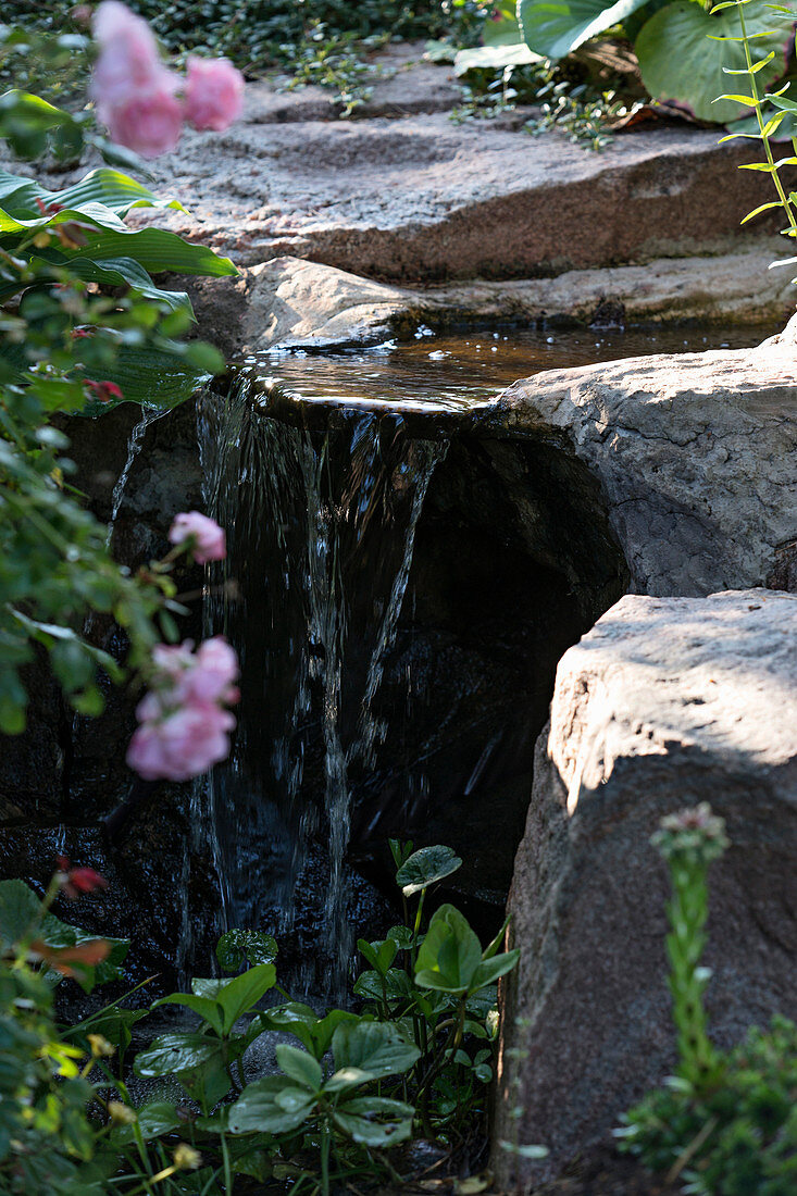 Water trickling from stone blocks in garden