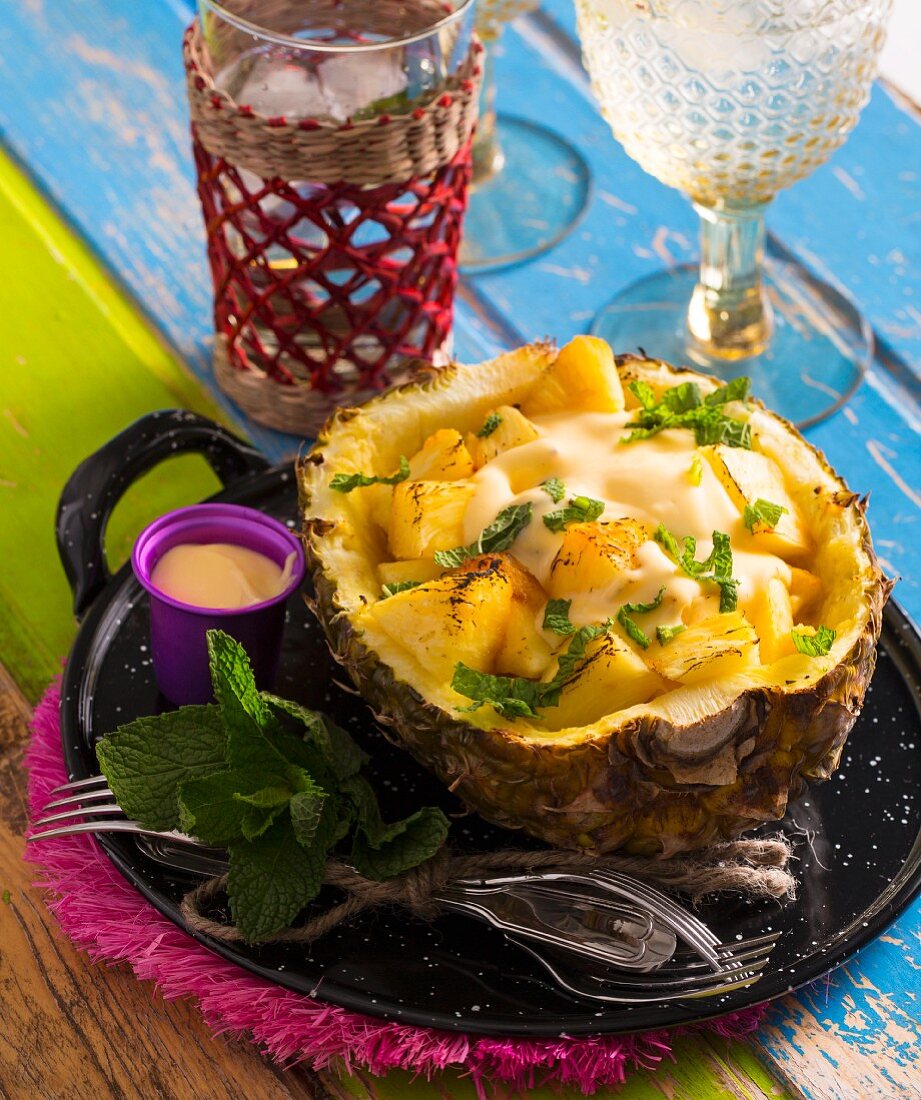 Grilled pineapple served in a hollowed out fruit