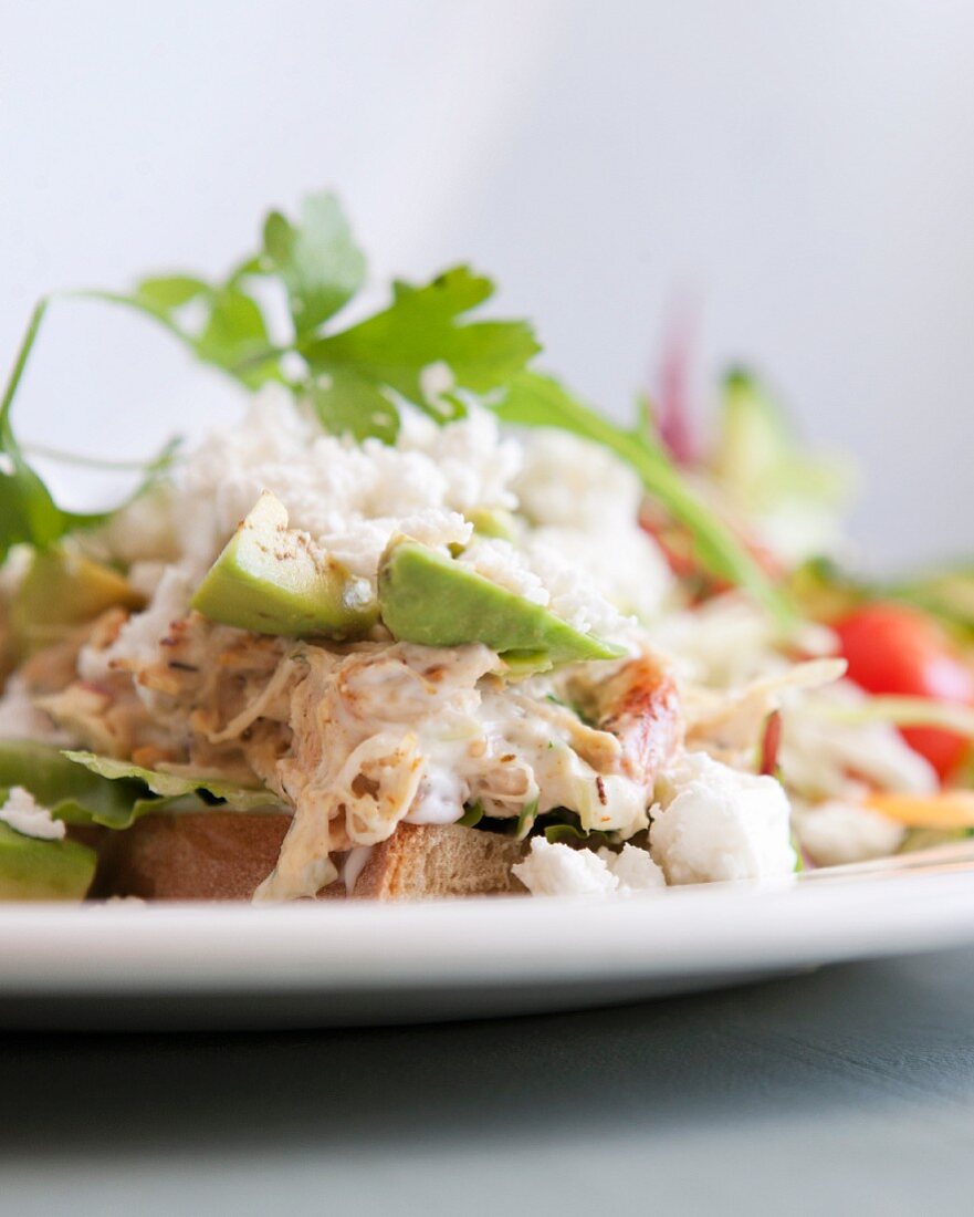 Poultry salad with feta and avocado on bread