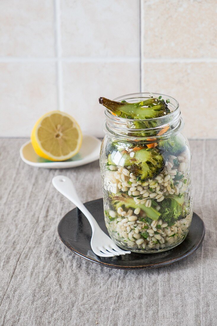 A broccoli and barley salad in a glass jar