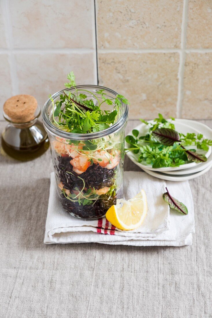 Black rice salad with shrimps in a glass