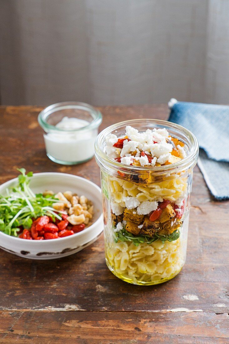 Layered salad with farfallini pasta, pumpkin and feta