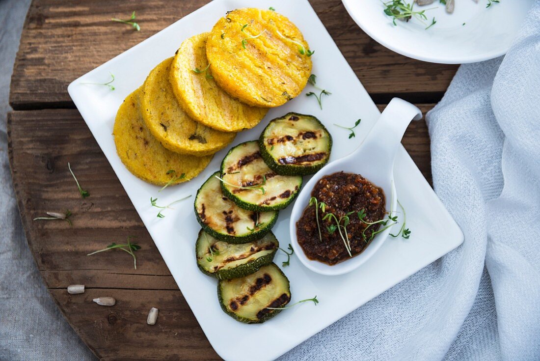 Grilled polenta and courgette slices with sunflower seed and tomato pesto (vegan)