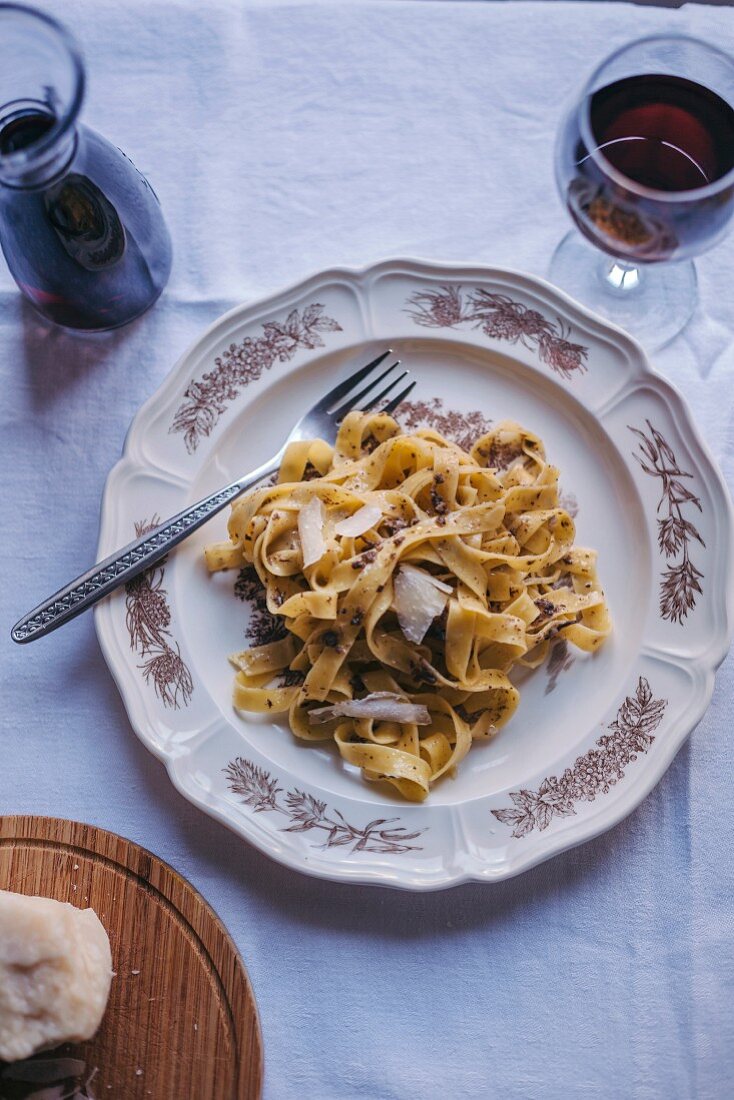 Tagliatelle pasta with black truffle served on a vintage plate