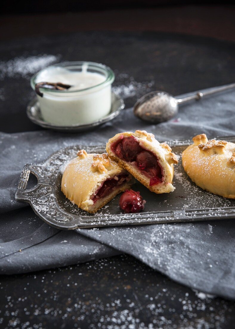 Vegan yeast pastries filled with sour cherries and vanilla sauce