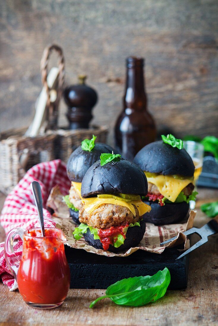 Black burgers with cheese and ketchup