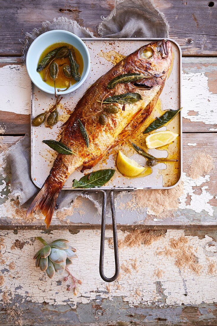 Whole baked fish with lemon and caperberry butter