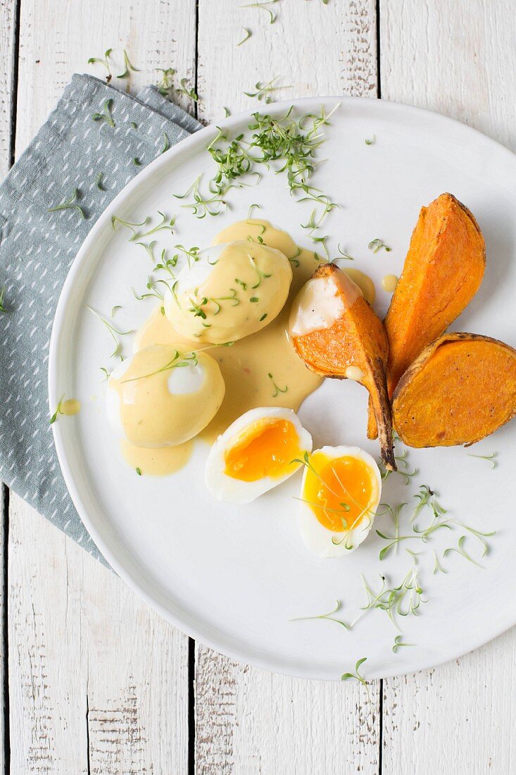 Eggs in mustard sauce with sweet potatoes and cress