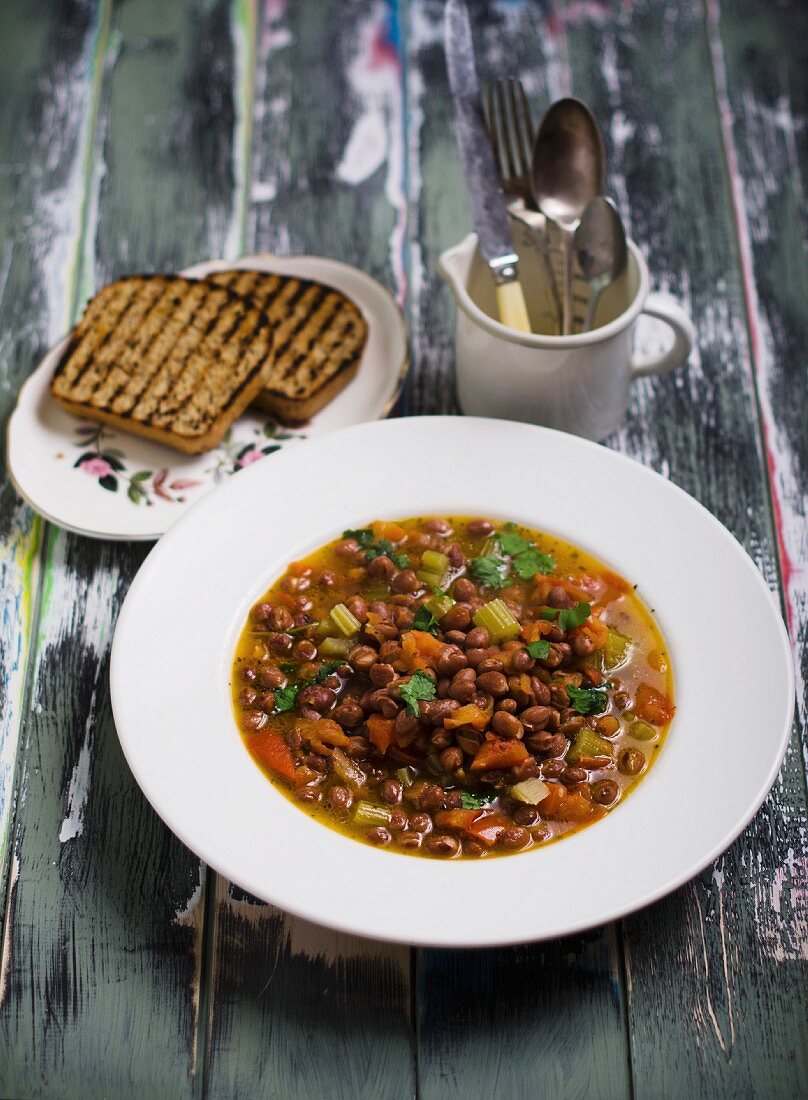 A mixed bean dish with toasted bread