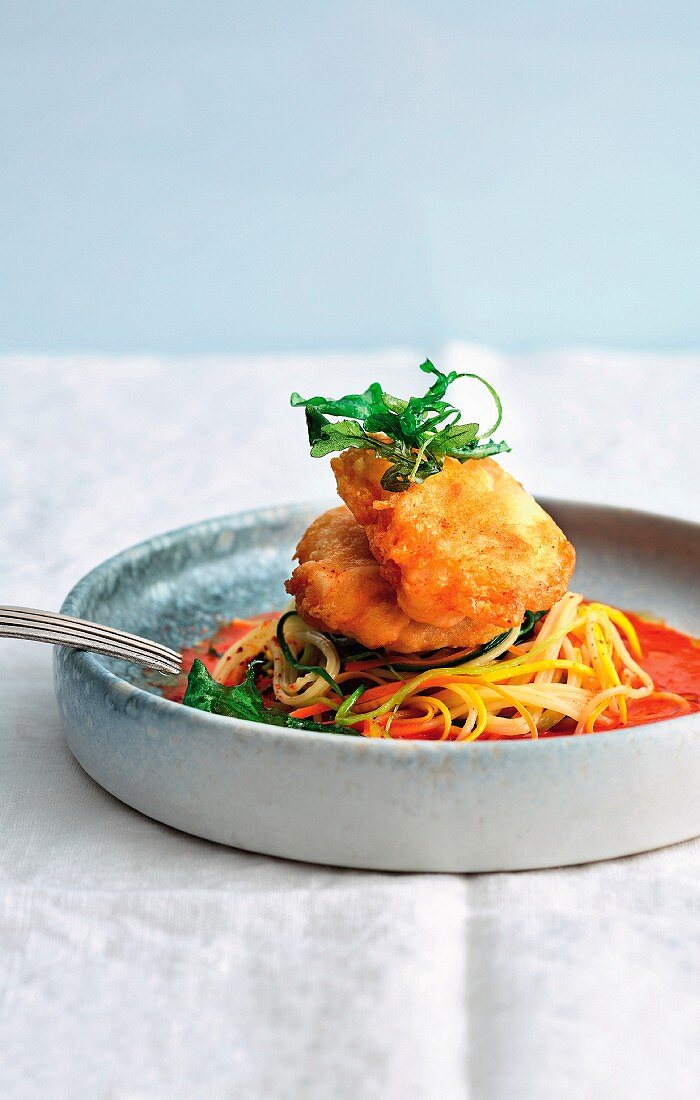 Monkfish piccata on vegetable spaghetti in sweet and sour tomato and pepper sauce